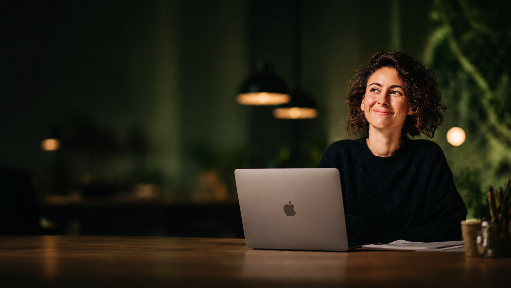 Shopify merchant smiling at her laptop